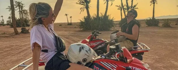 Rider enjoying a quad biking adventure through the palm groves of Palmeraie, Marrakech, with lush greenery and desert trails in the background.