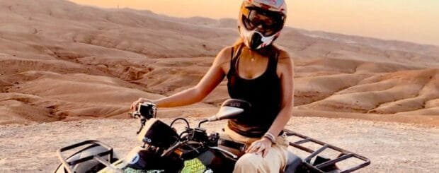 A rider enjoying an adventurous quad biking experience on the rugged trails of Marrakech, surrounded by breathtaking desert scenery.