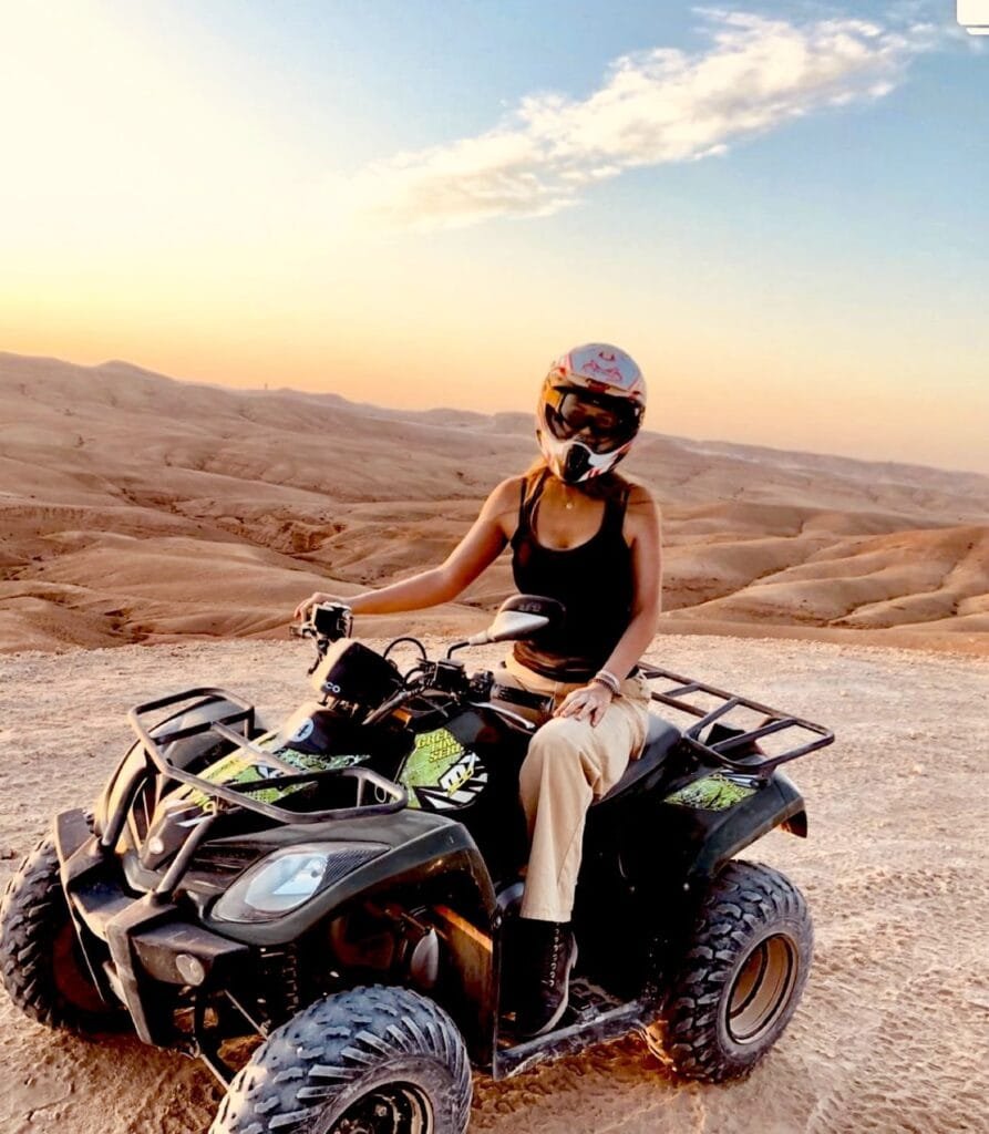 A rider enjoying an adventurous quad biking experience on the rugged trails of Marrakech, surrounded by breathtaking desert scenery.