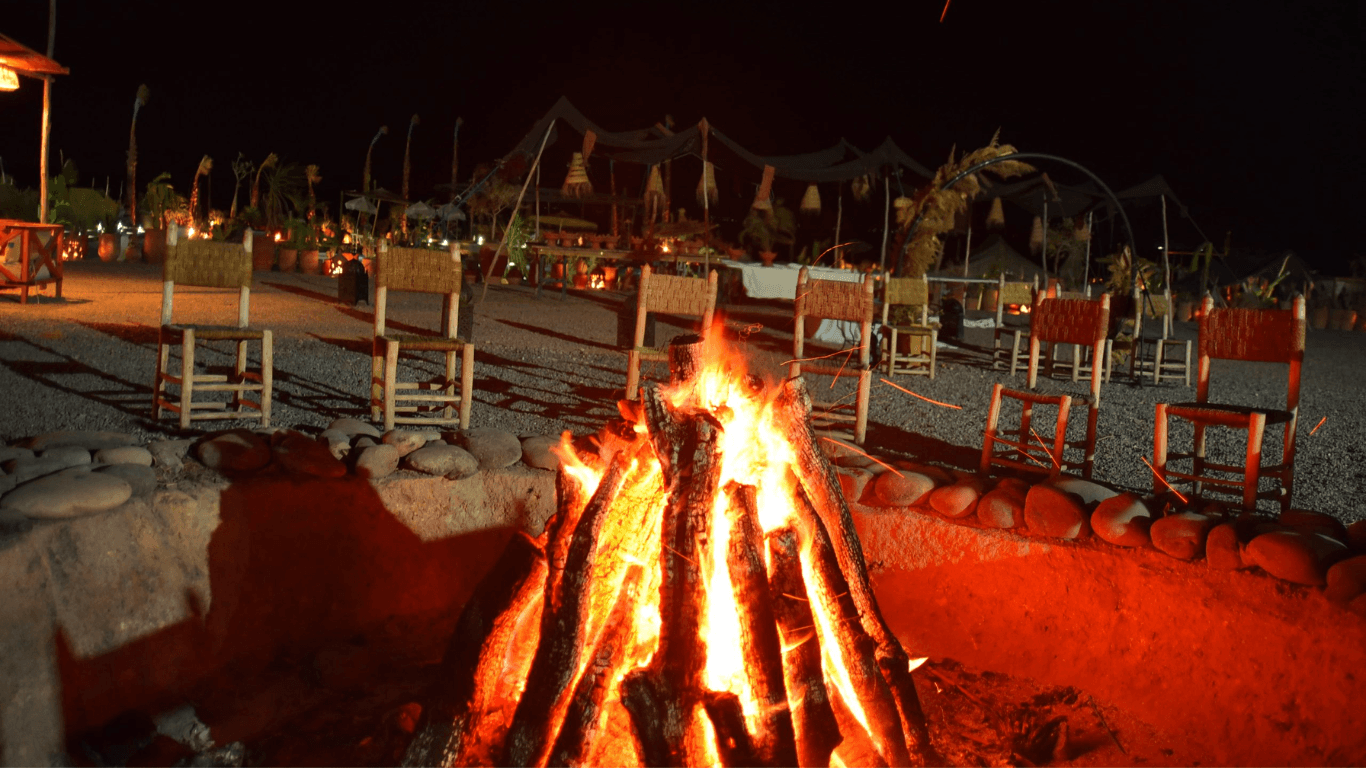 Fire performer showcasing an exciting fire show in the Agafay Desert at night.