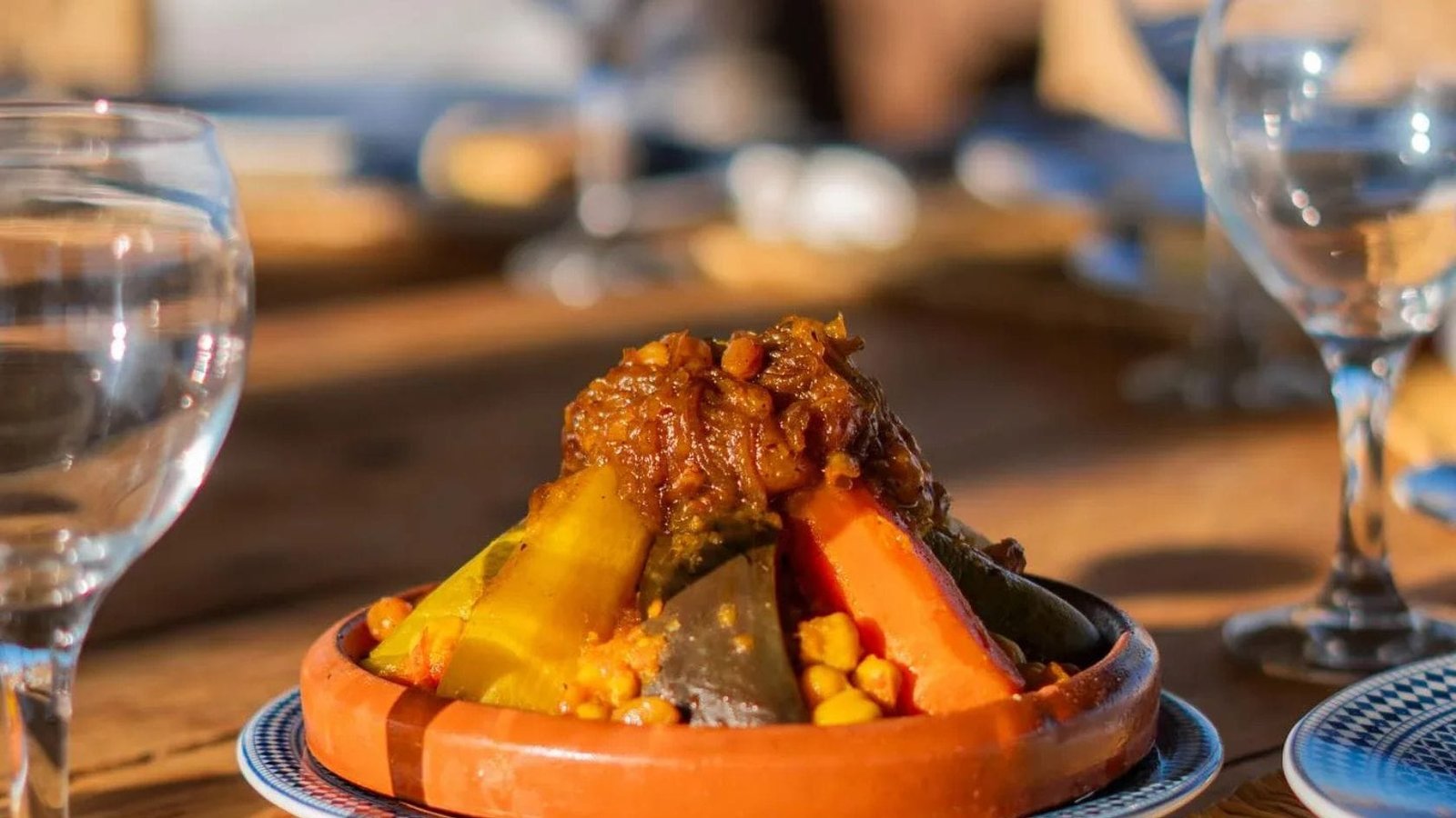 Traditional Moroccan vegetable couscous served in a clay dish at an Agafay Desert dinner.