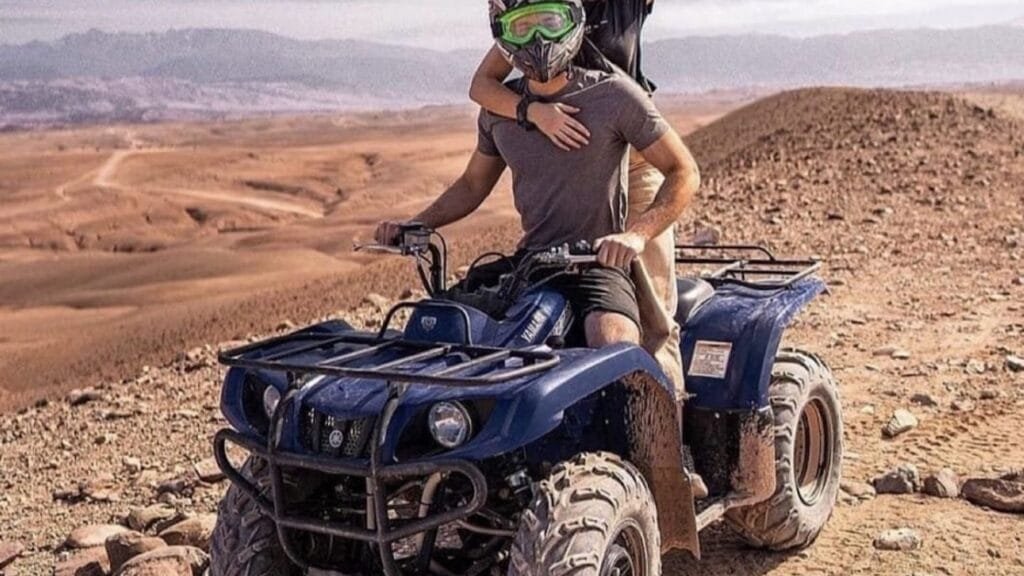 A couple riding quad bikes together in the Agafay Desert near Marrakech.