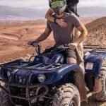 A couple riding quad bikes together in the Agafay Desert near Marrakech.