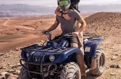 A couple riding quad bikes together in the Agafay Desert near Marrakech.