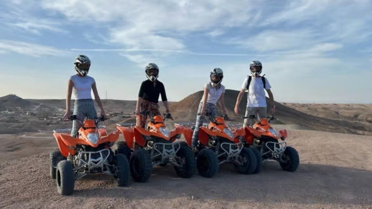 Family group quad biking together in the Agafay Desert near Marrakech.