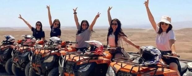 Group of people quad biking together in the Agafay Desert near Marrakech.