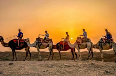 Group enjoying a camel ride at sunset in the Agafay Desert.