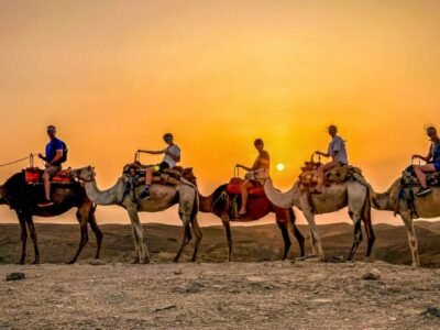 Group enjoying a camel ride at sunset in the Agafay Desert.